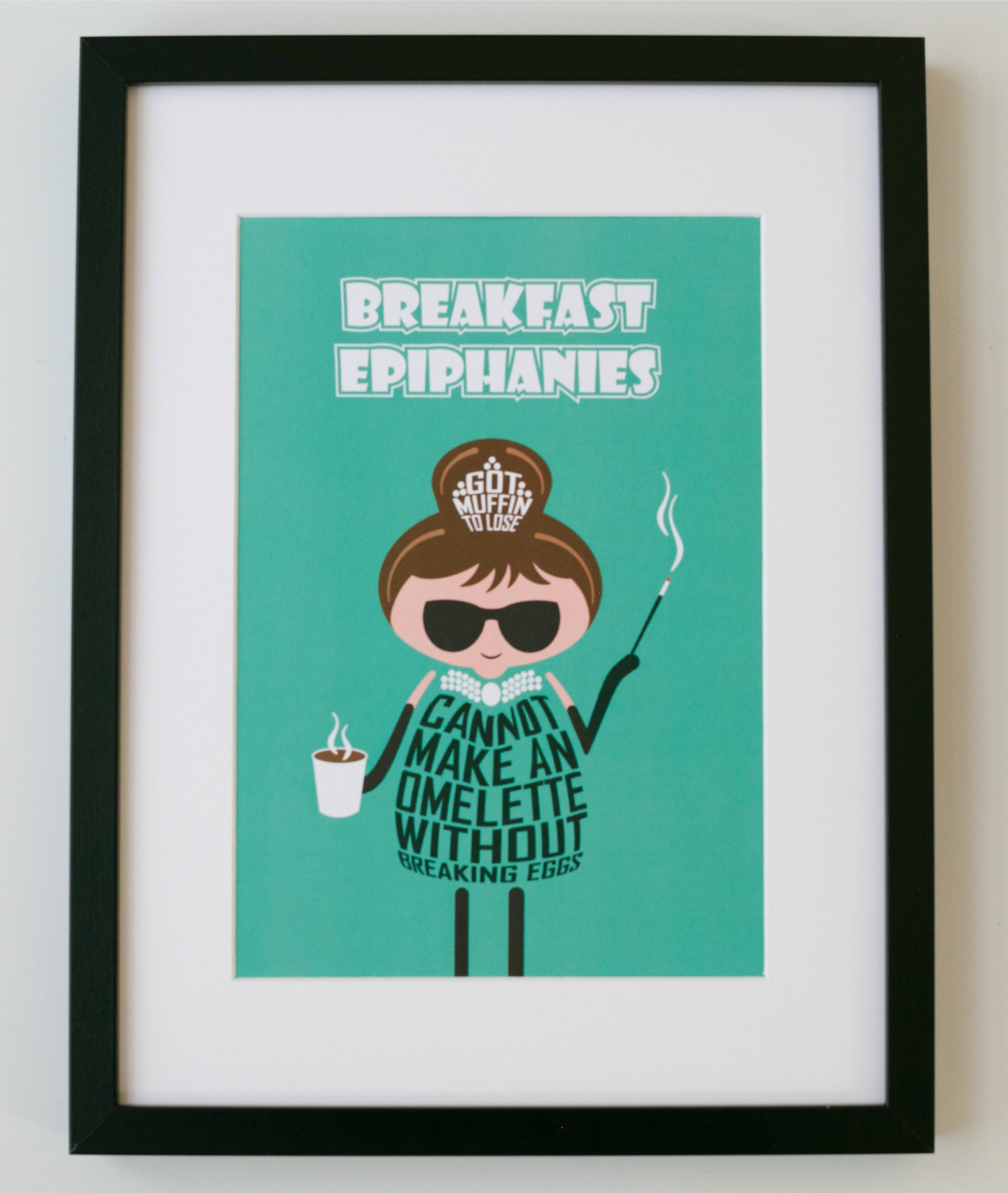 Proudly designed and printed in the UK on high quality, FSC-certified, 350gsm board, this unframed A4 print is headlined "Breakfast Epiphanies" - a cute take on Breakfast at Tiffany's. The Audrey Hepburn-inspired cartoon character's clothing then expresses the additional wording: "Got muffin to lose" and "Cannot make an omelette without breaking eggs"