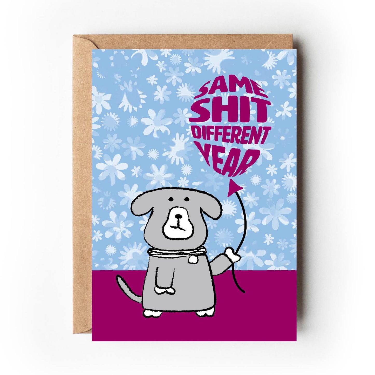 Cartoon dog with perturbed facial expression holds a burgundy-coloured balloon which is printed with wording which says Same Shit, Different Year.  All set on pale blue floral backdrop which looks like old-fashioned wallpaper. 