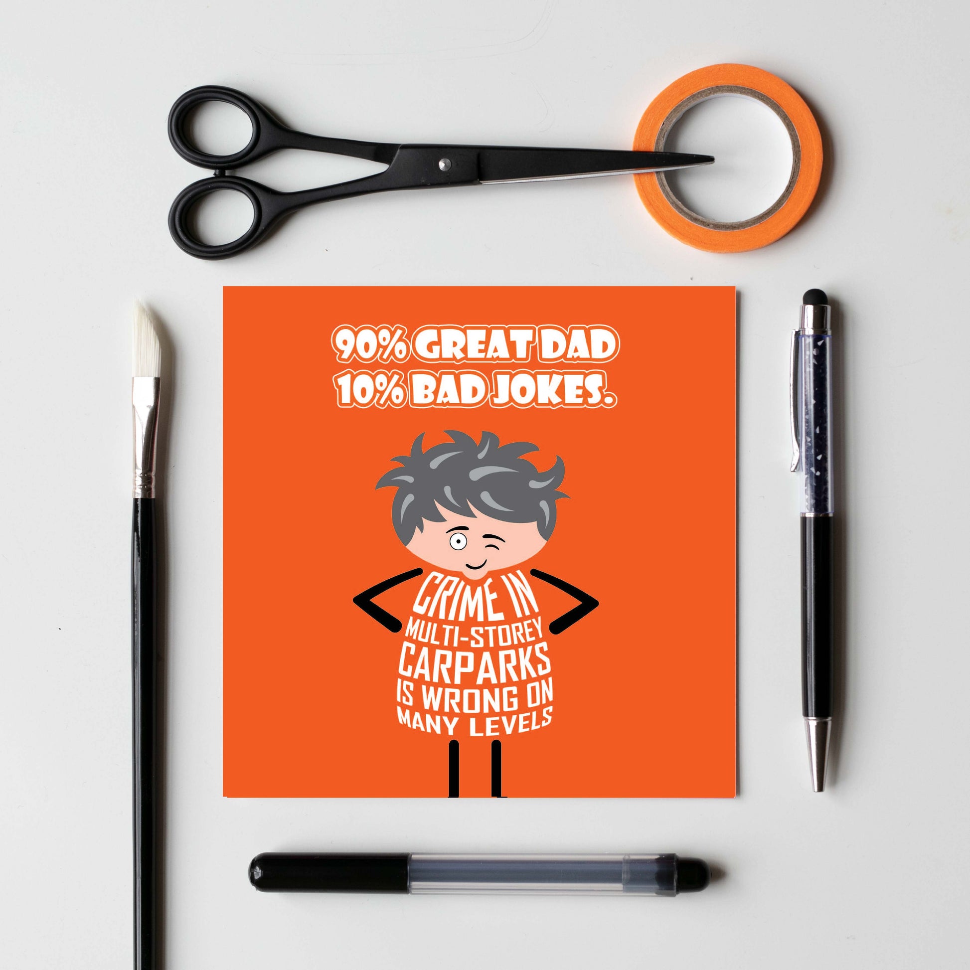 Card titled “90% Great Dad, 10% Bad Jokes” in white text on an orange background. A cartoon Dad stands with his hands on his hips and while winking he says “Crime in multi-storey carparks is wrong on many levels.” Card is 150mm square. Supplied with eco-Kraft envelope.  