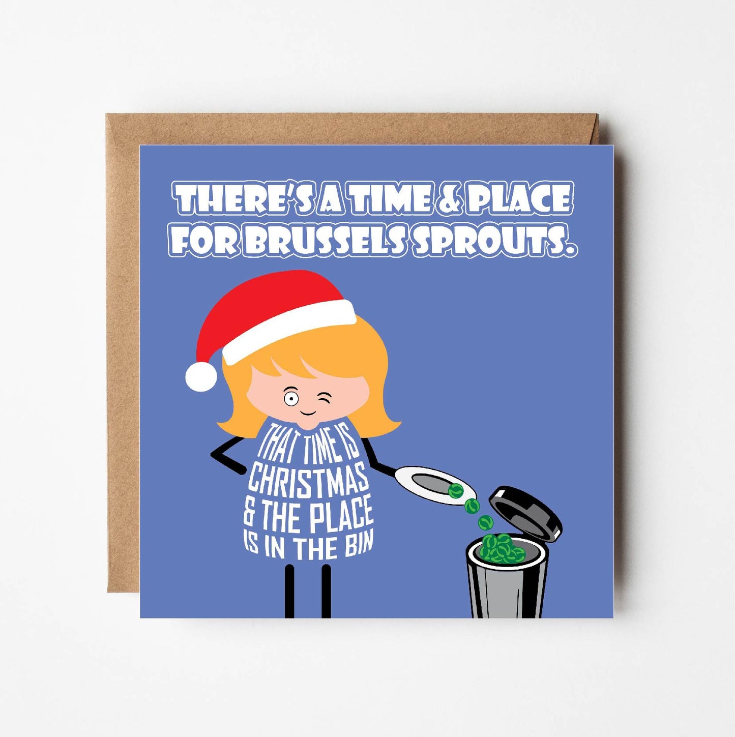 Card titled There’s A Time And Place for Brussels Sprouts.  A cartoon lady empties her plate of brussels sprouts in to the bin while winking and saying The time is at Christmas and the place is in the bin.  Card is square and supplied with eco-Kraft envelope.