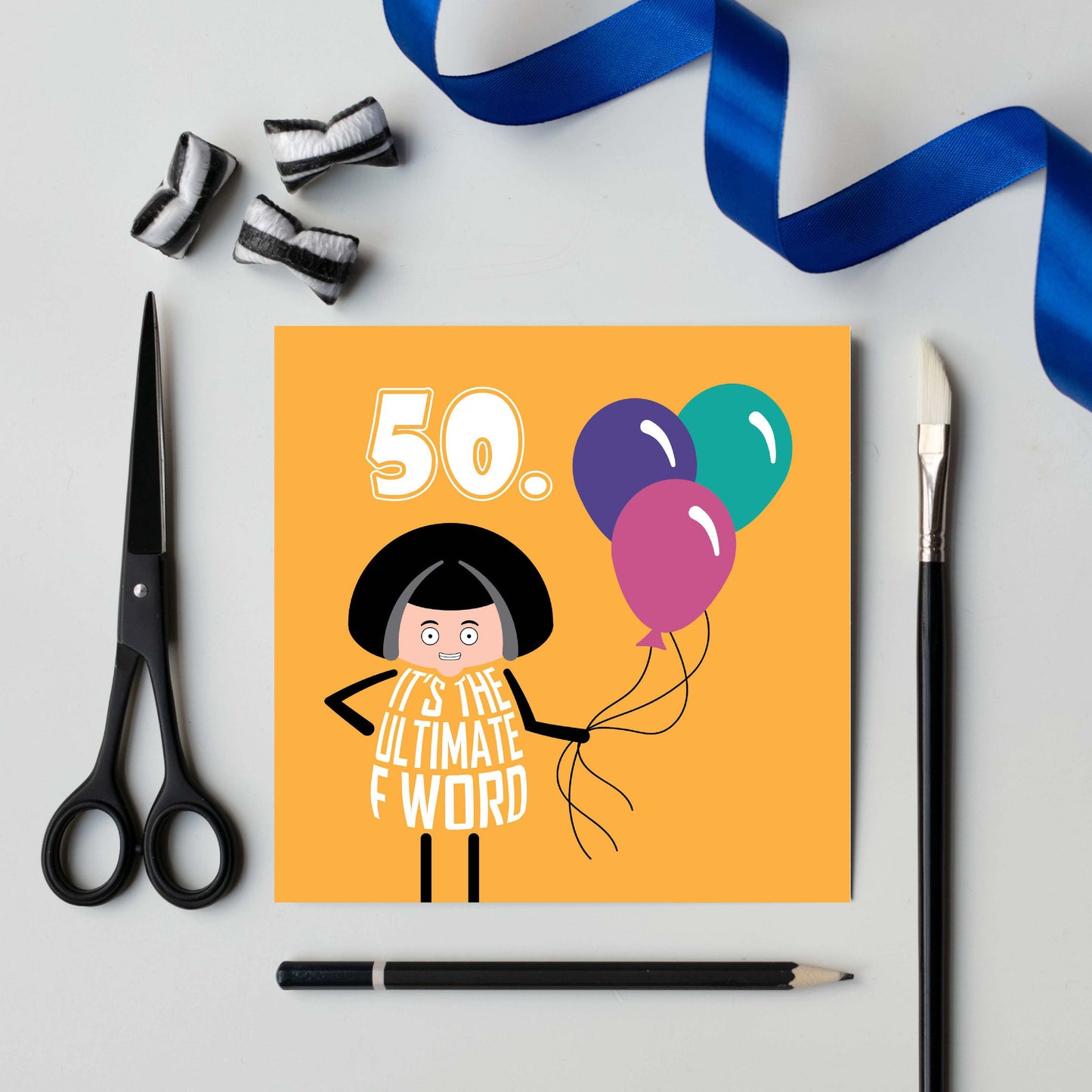 Text on card says Fifty in white text on yellow background.  A cartoon lady with a wry smile on her face holds a balloon. Lettering on her dress says It's the Ultimate F Word.  Card is 150mm square and supplied with eco-Kraft envelope.