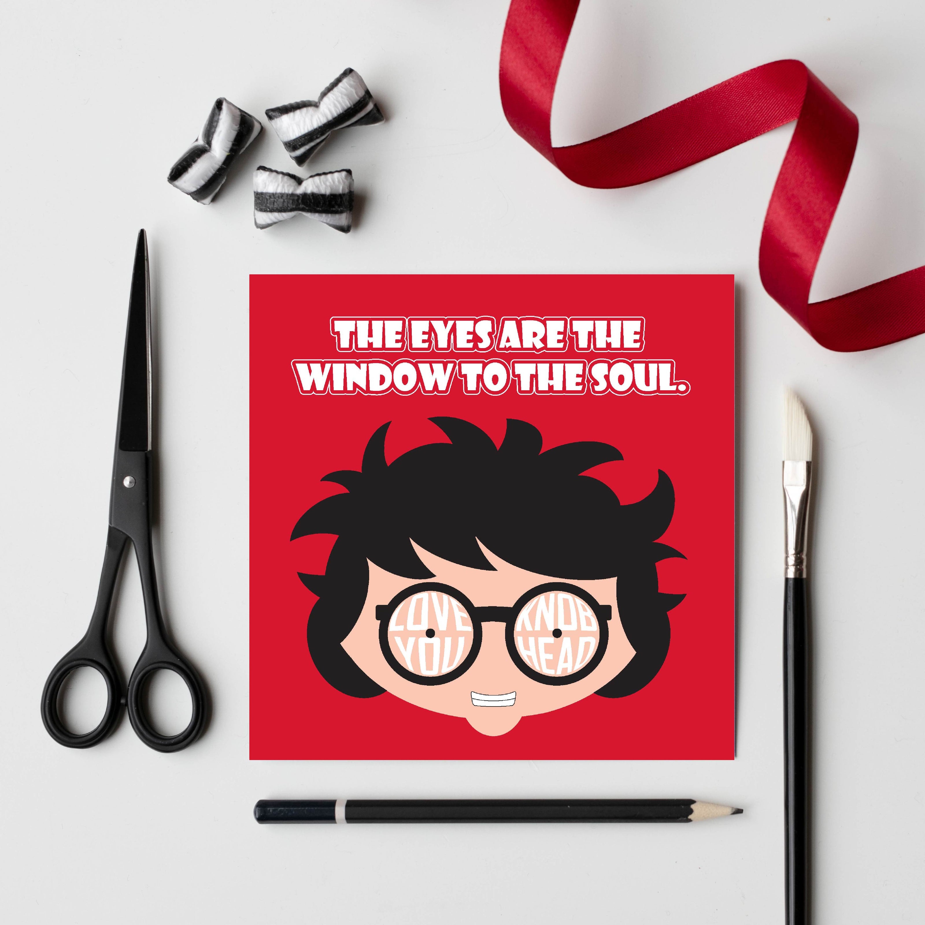 Card titled The Eyes are the Window to the Soul in white text on red background.  Close up of cartoon head which is grinning and wearing round glasses.  Text forms the lens of the glasses which says Love you, Knobhead.  Card is 150mm square and supplied with eco-Kraft envelope.